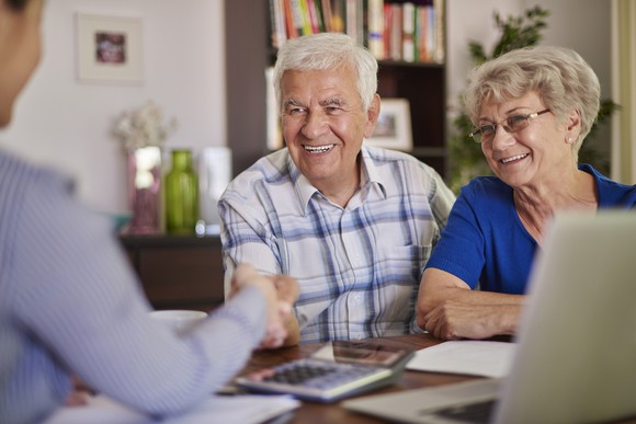 Retired couple talking with agent