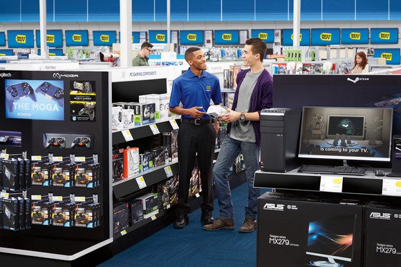 A Best Buy employee helping a customer inside a Best Buy store.