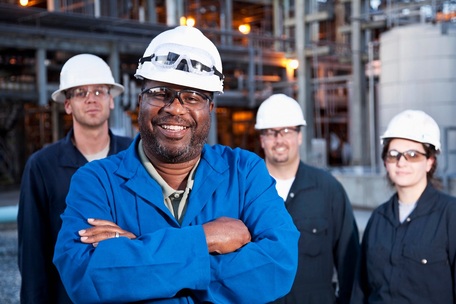 Employees of a petrochemical facility pose for a photo. 