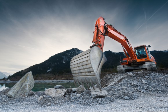 A red excavator at a mineral mine. 