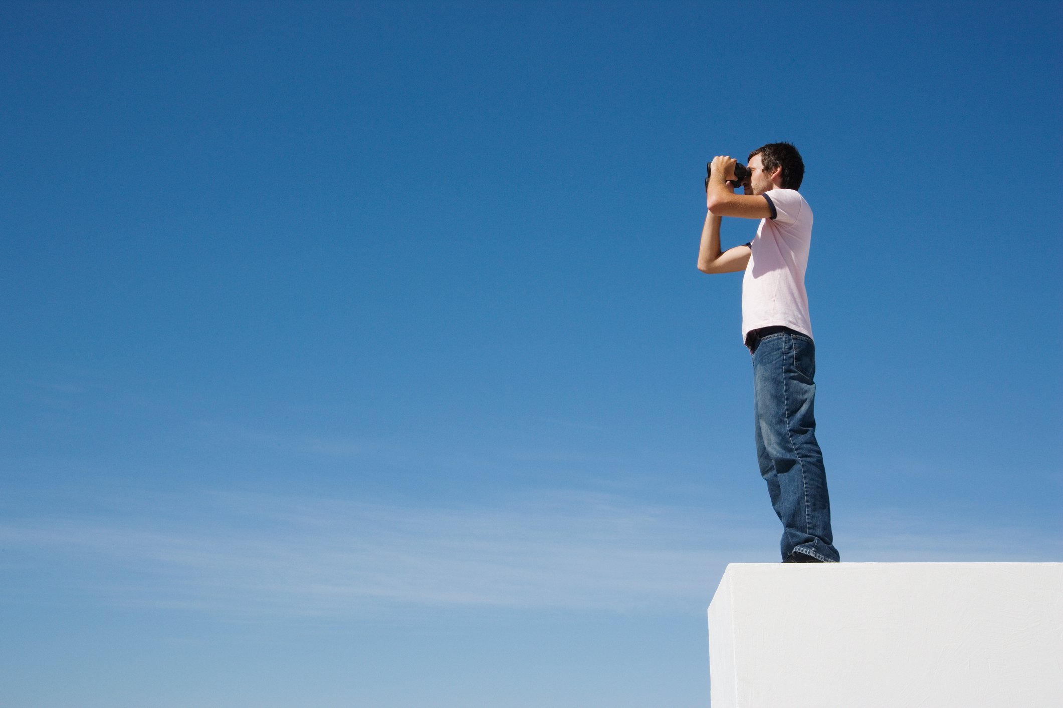 Man staring in a pair of binoculars. 