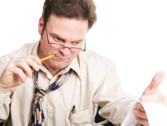 A man struggles to calculate a budget.