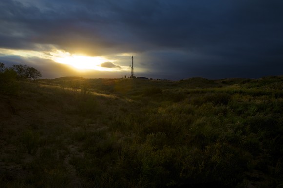 A drilling rig at sunset. 