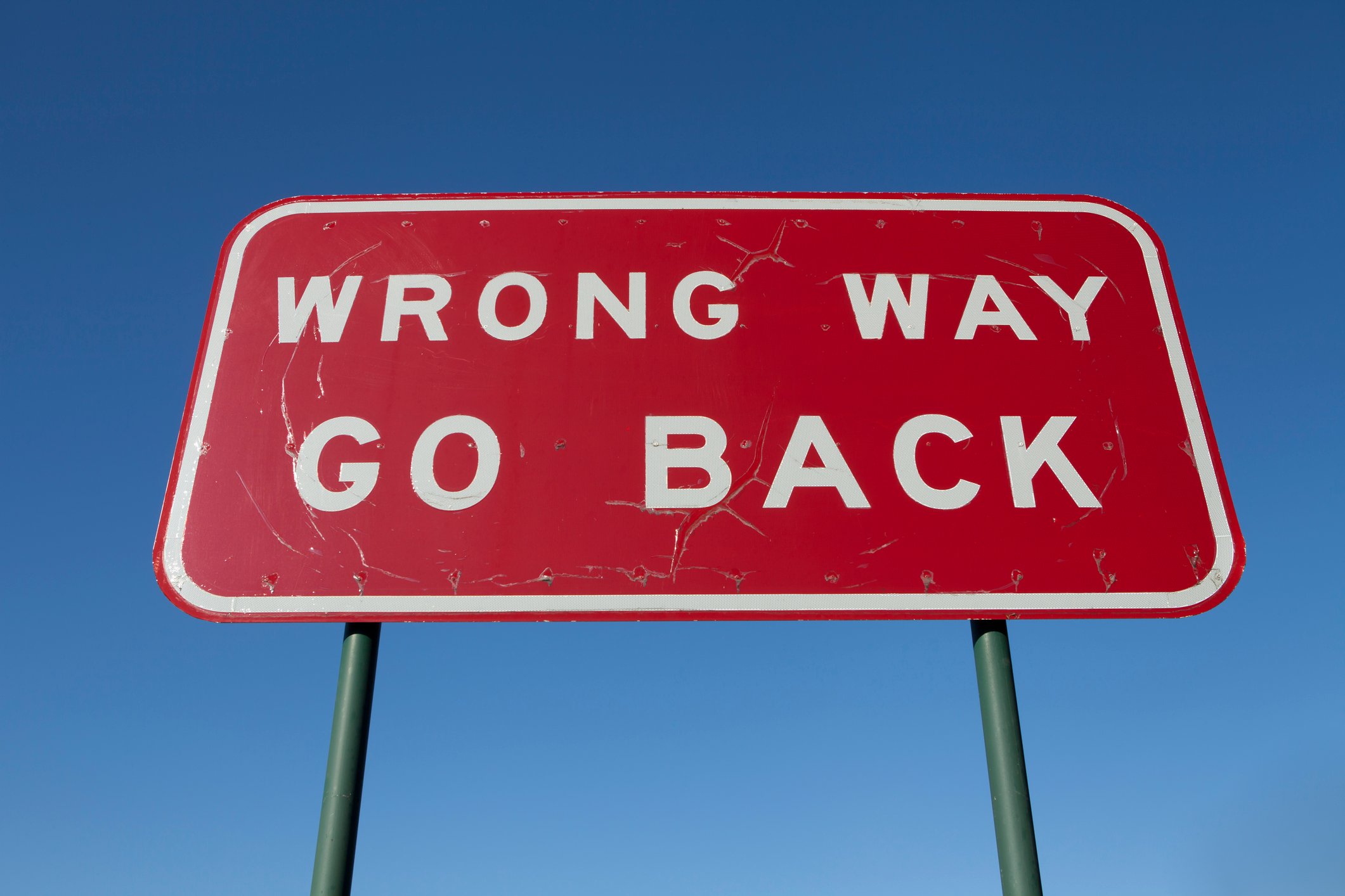 Wrong way go back sign.