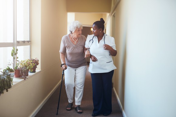 Elderly patient walking with a doctor