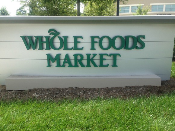 A sign at the entrance to a Whole Foods Market