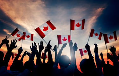 Group waving Canadian flags