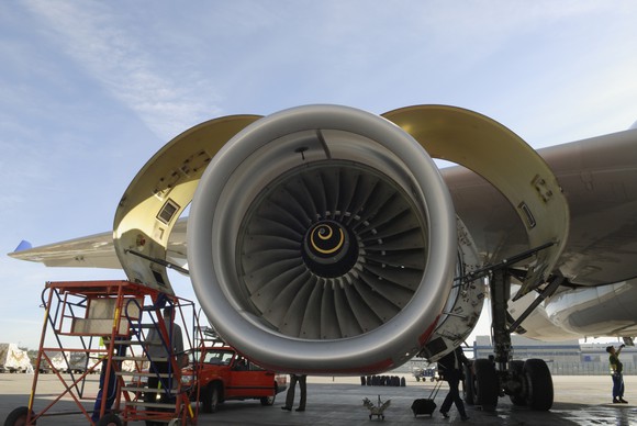 A jet engine being opened for routine maintenance.