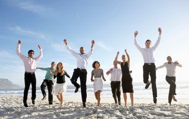 businesspeople on beach cheering getty
