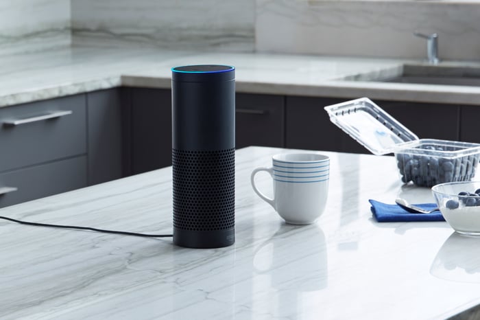 Amazon Echo device siting on a kitchen counter. 