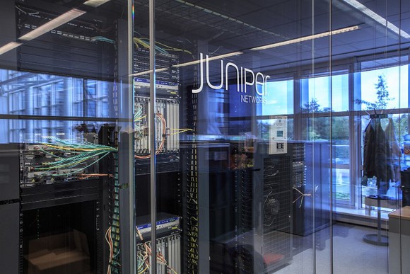 The outside of a glass office door that says Juniper on it. 