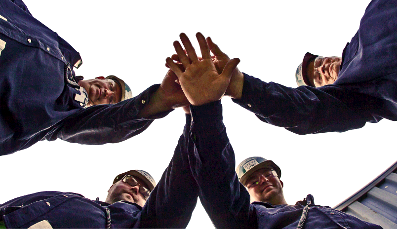 Steelworkers put their hands together in a sign of solidarity.