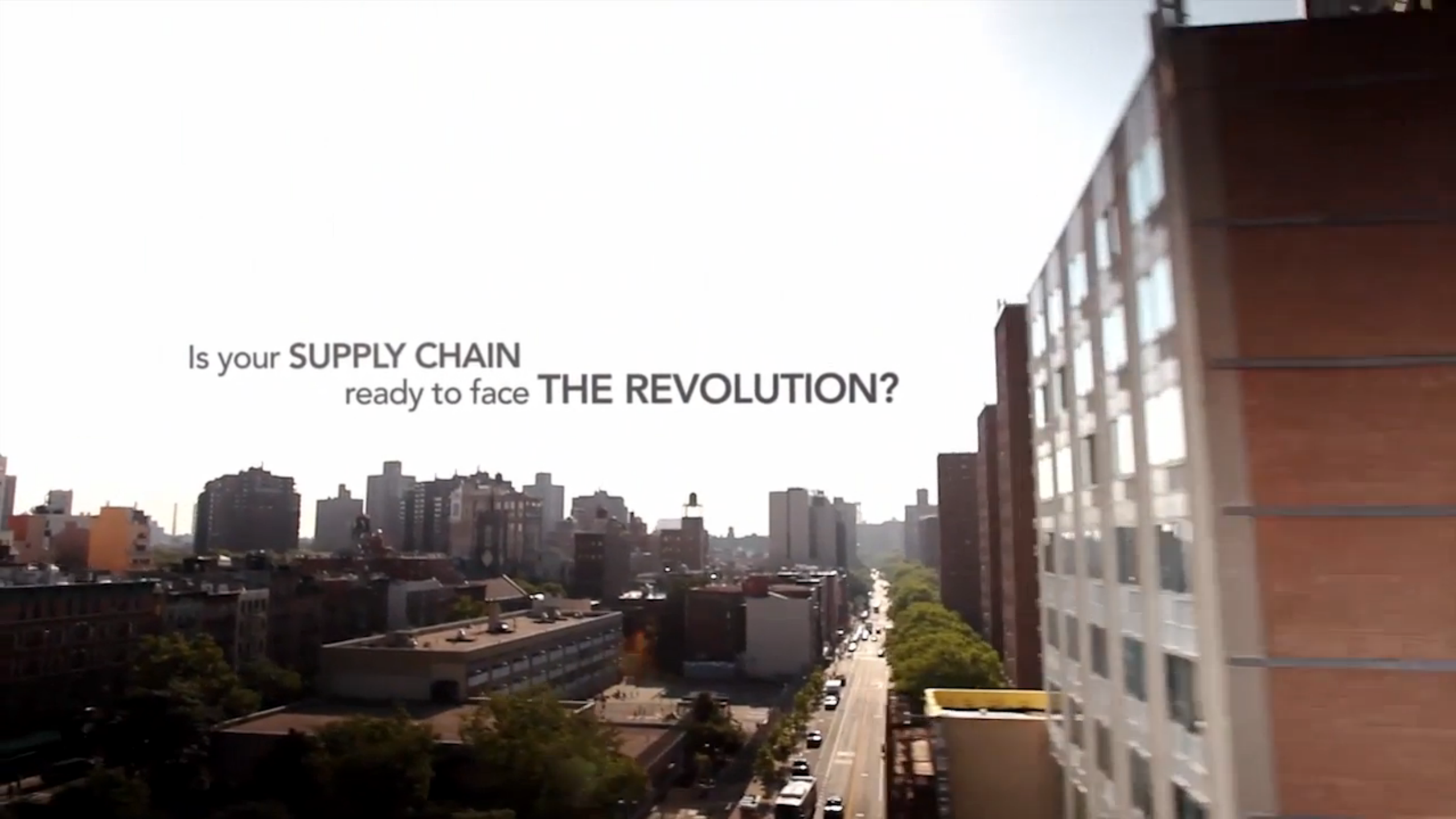 Marketing material from Manhattan Associates, showing a city view from a high vantage point.