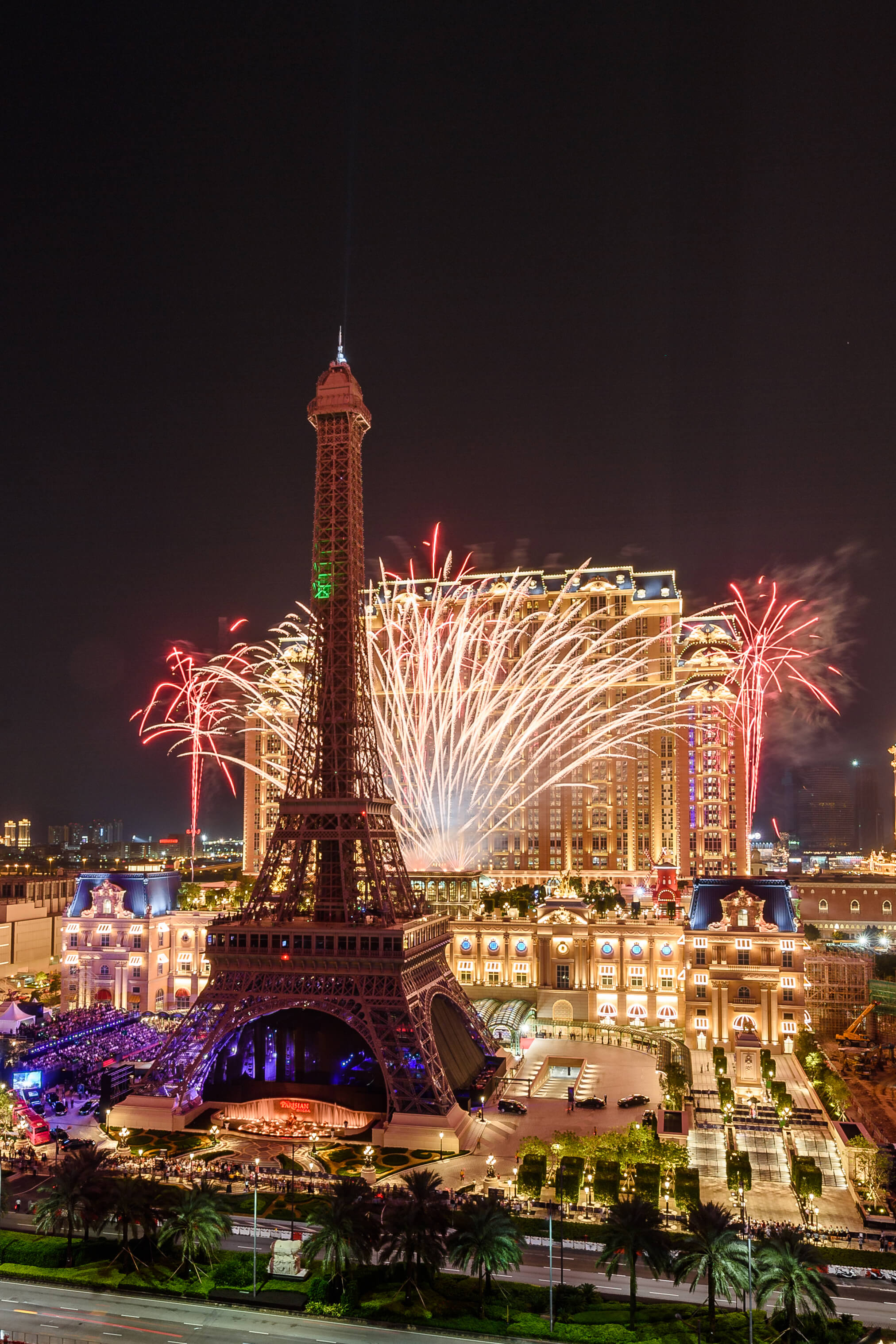 The Eiffel Tower replica at the Parisian, with fireworks behind it.
