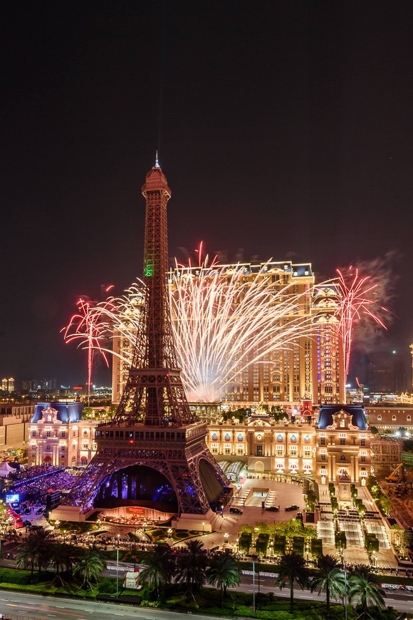 The Eiffel Tower replica at the Parisian, with fireworks behind it.