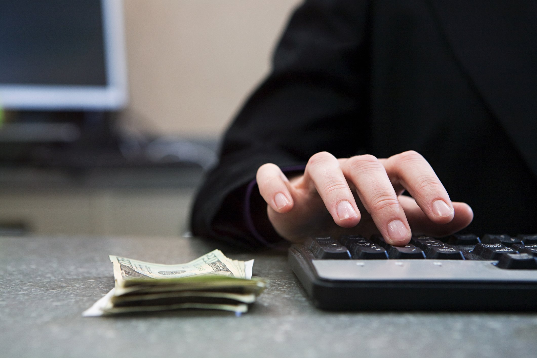 Bank teller counting money.