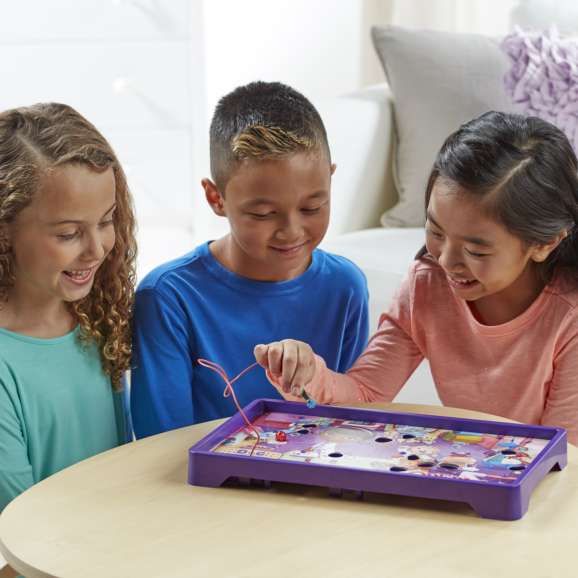 Three children play Doc McStuffins operation board game. 