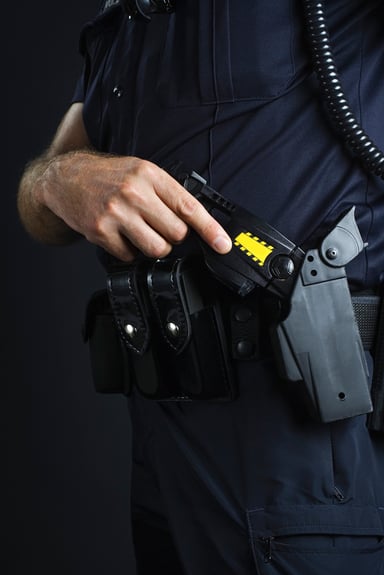 Taser Axon Stun Gun Held by Police Officer