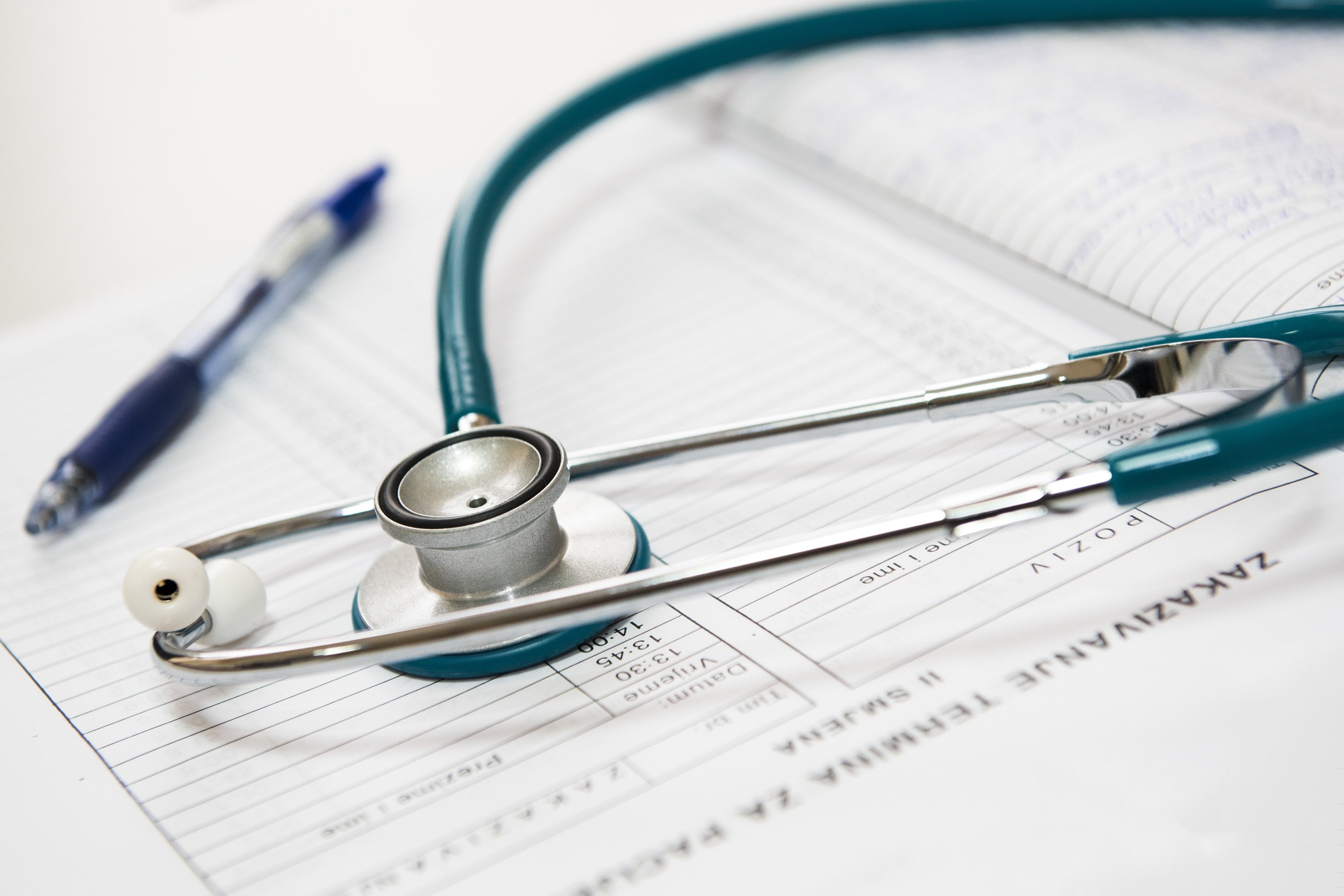 A stethoscope on top of medical papers.