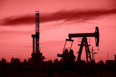 Land Drilling Oil and Gas Two Rigs in the Sunset