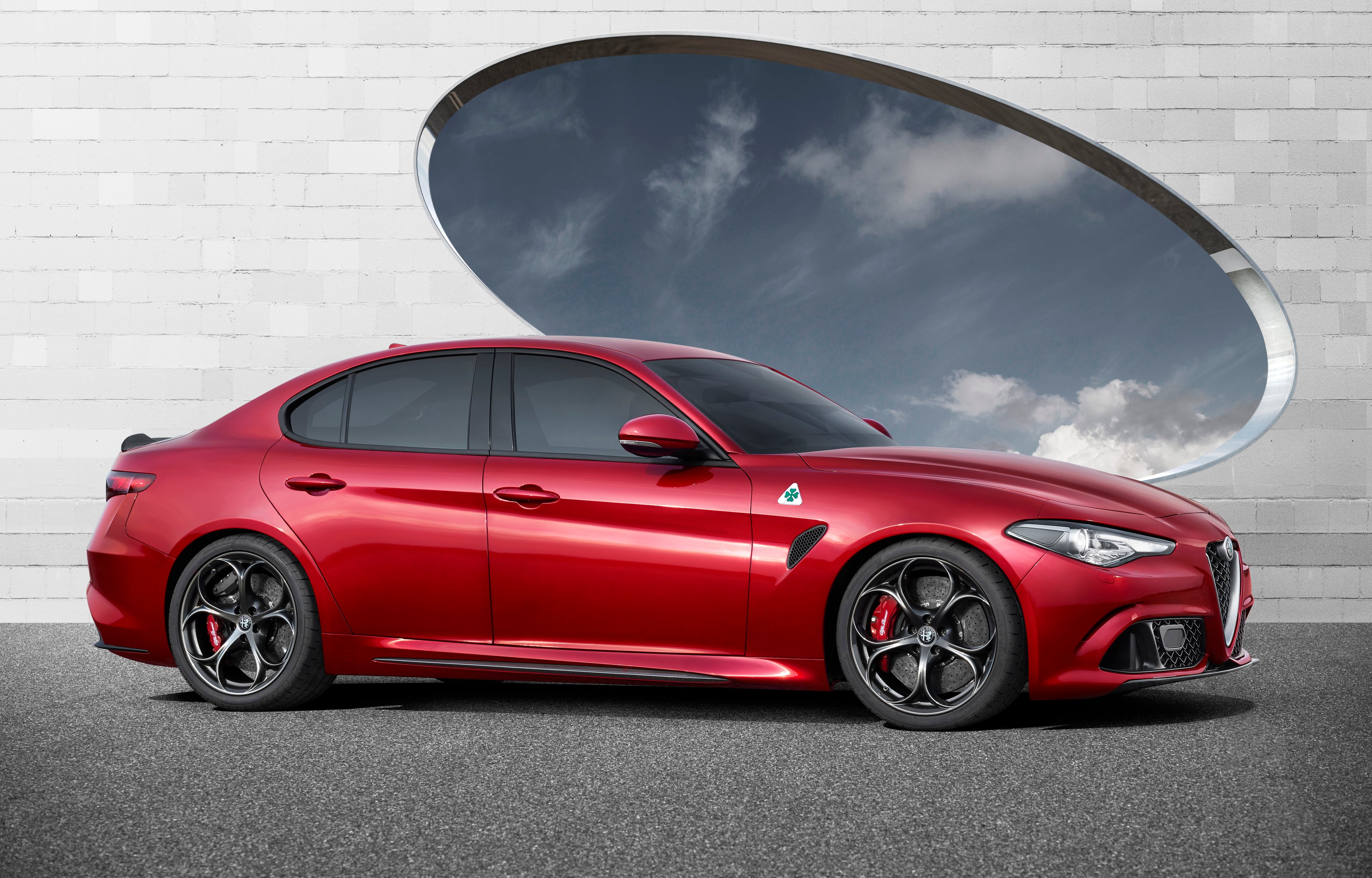 A red Alfa Romeo Giulia Quadrifoglio sedan. 