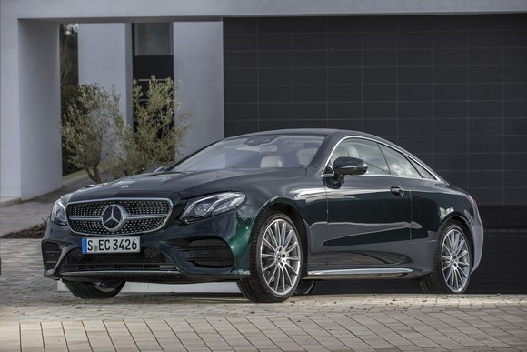 A green Mercedes-Benz E-Class coupe.