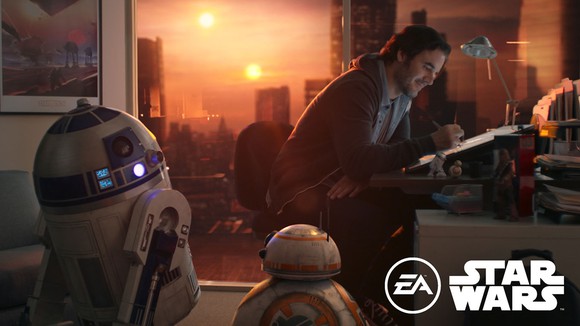 Artist drawing at a desk with Star Wars robot characters and setting surrounding the artist. 