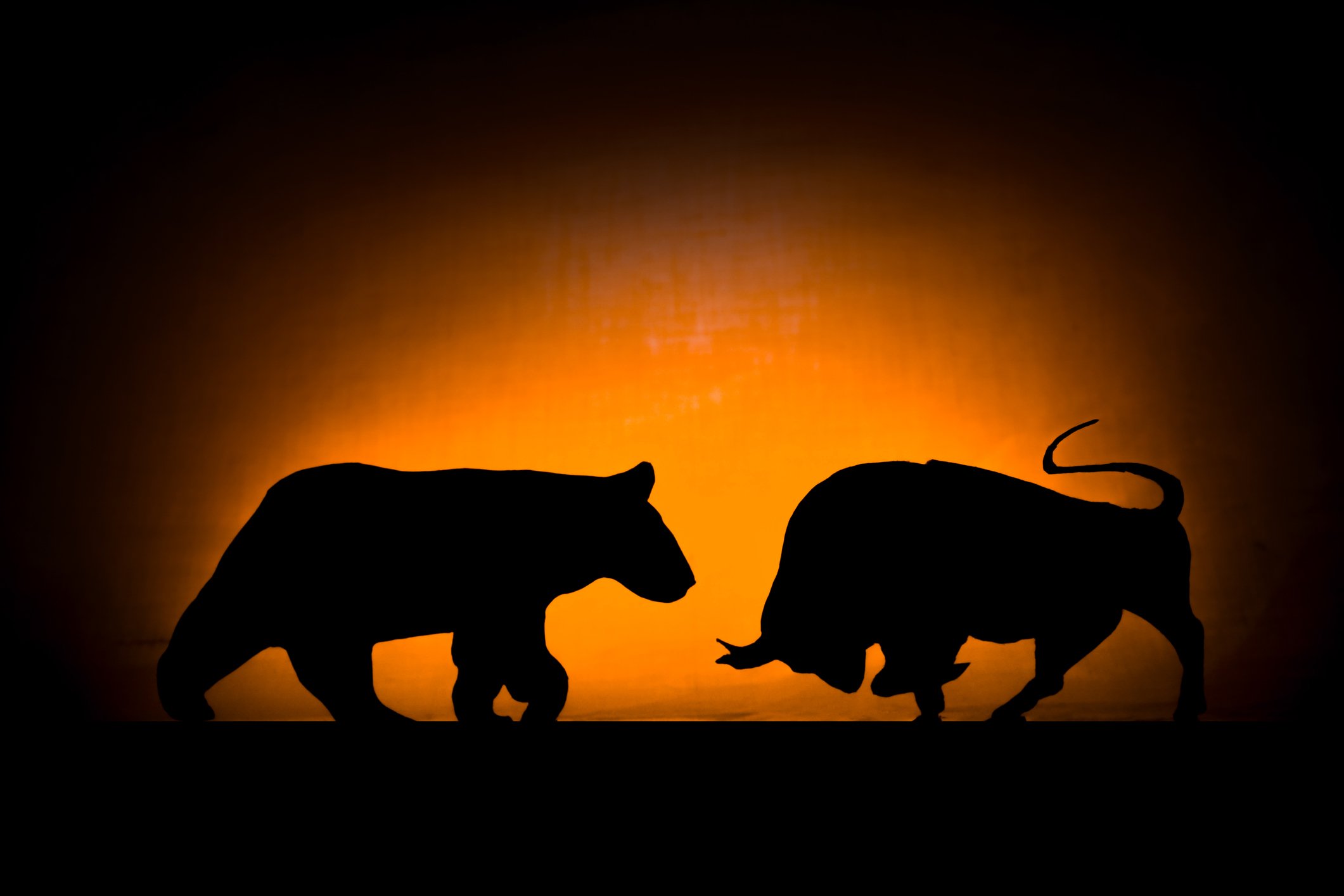 A bull and bear in silhouette.