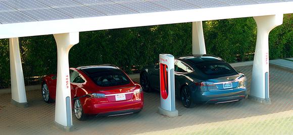 Tesla cars charging at a Supercharger site