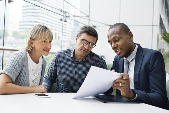 People sitting around a table discussing business.