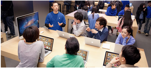 Image of people inside an Apple store. 