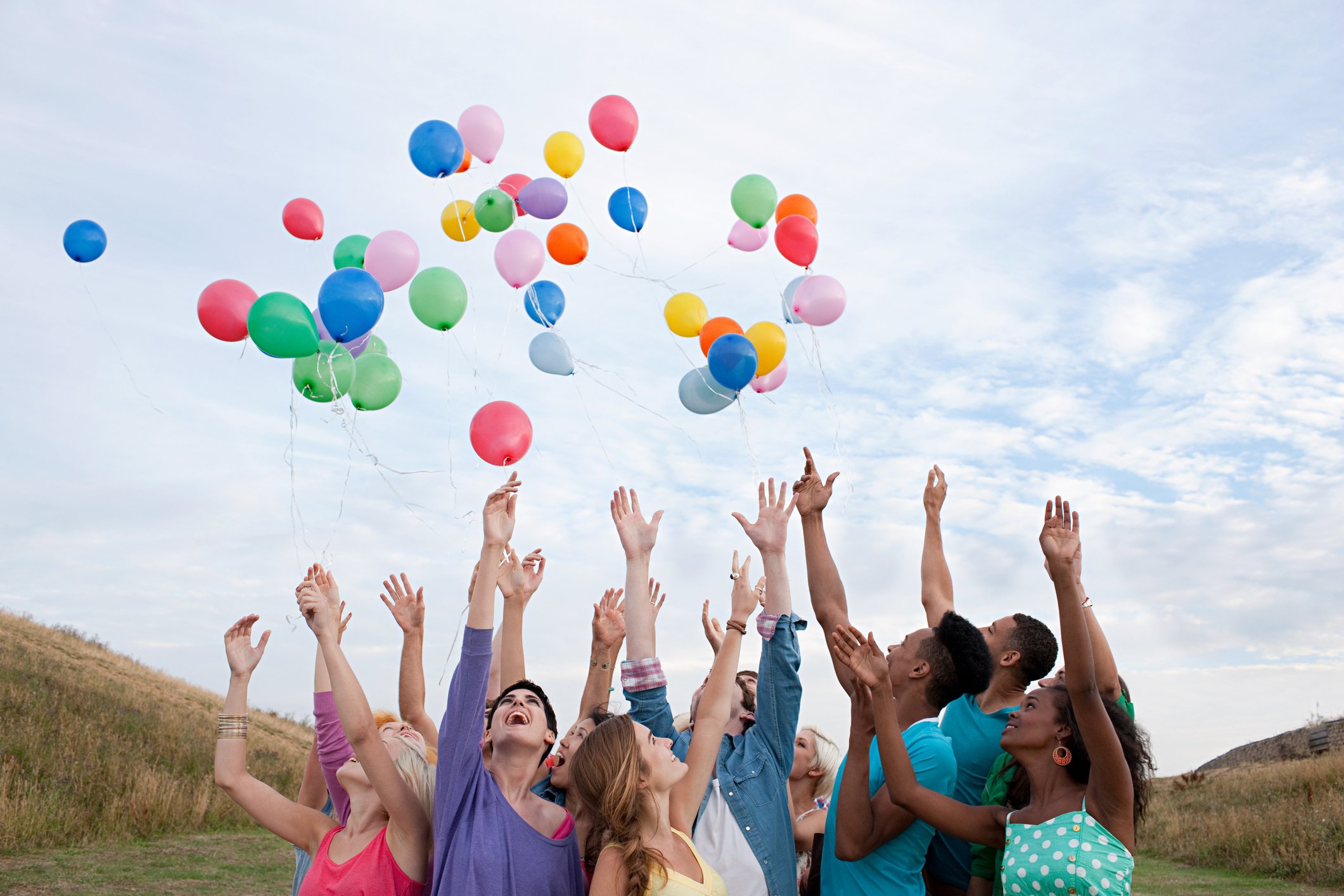 Group releasing balloons into the air