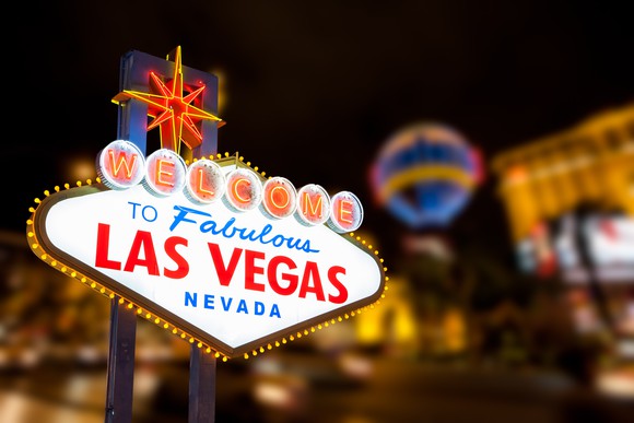 Las Vegas sign with strip street background.