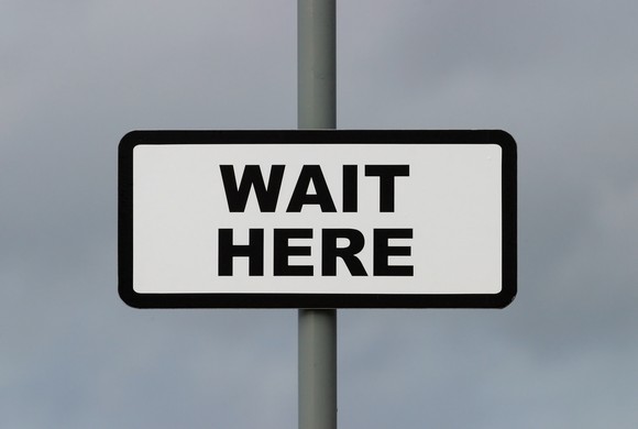 Sign that says, "wait here"