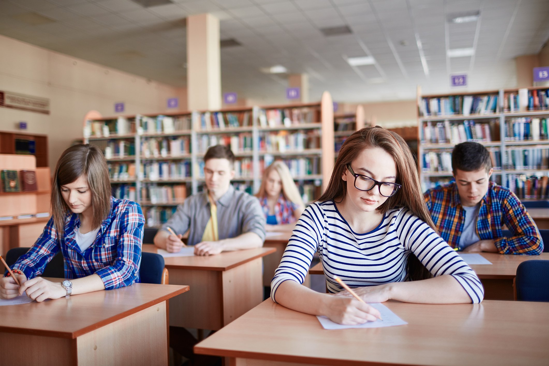 Students taking a test in a library