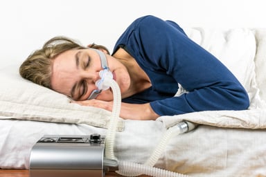 Sleep Apnea Woman Sleeping With CPAP Device