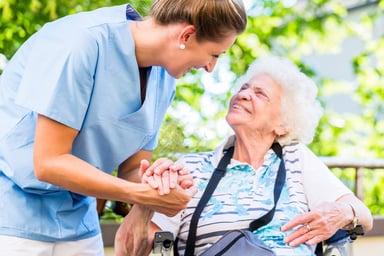 Caregiver_tending_to_elderly_woman