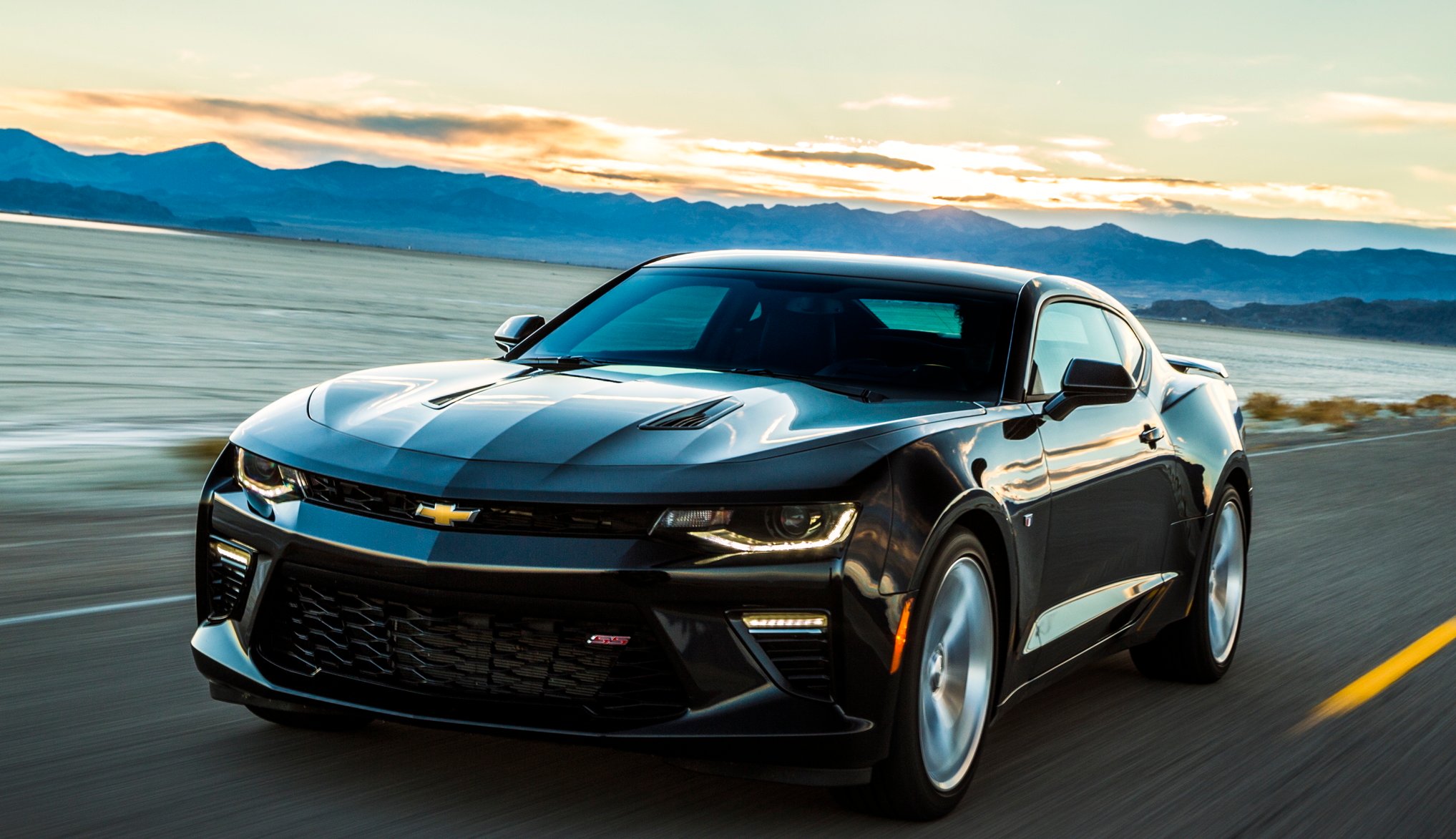 A Camaro coupe on a seaside road.