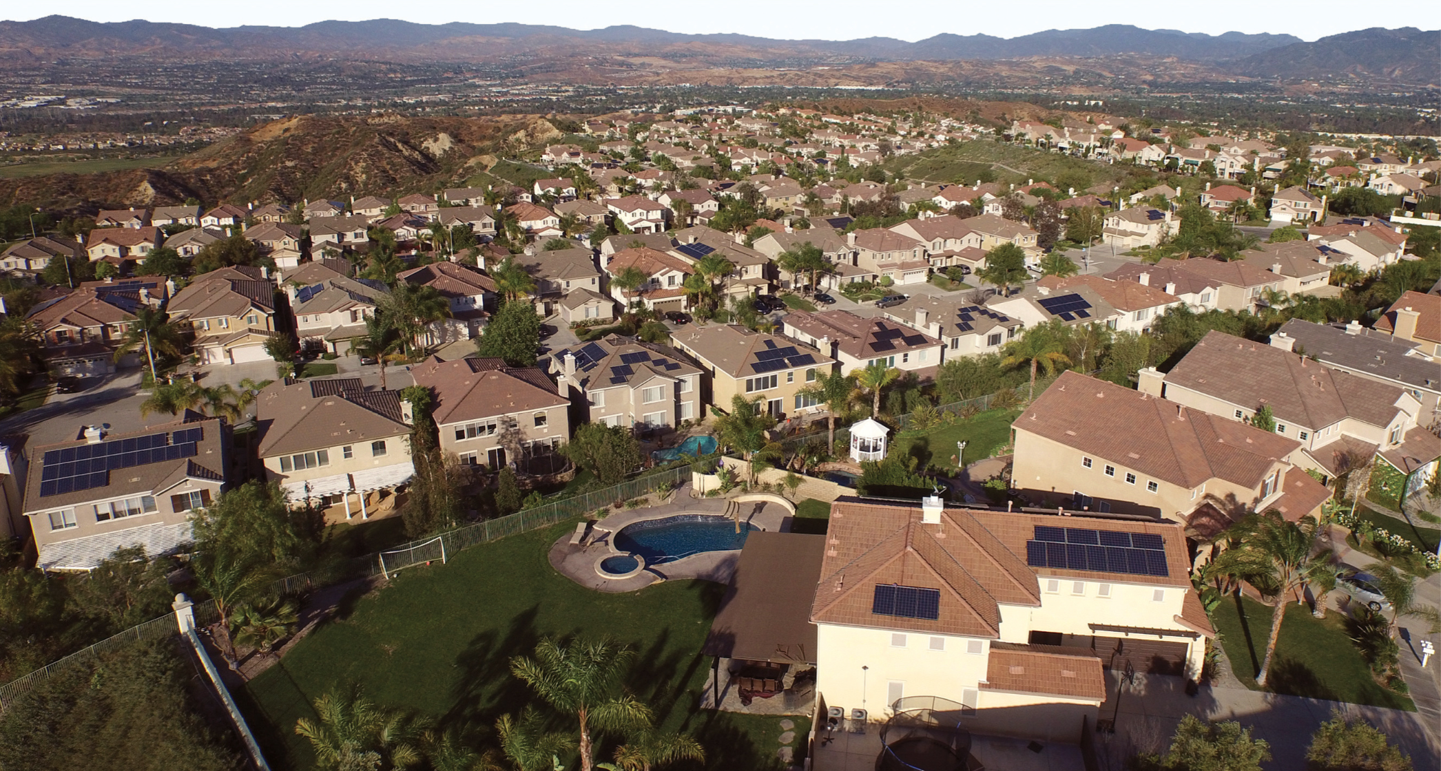 Neighborhood with solar installations on their roof.