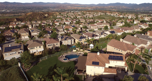 Neighborhood with solar installations on their roof.