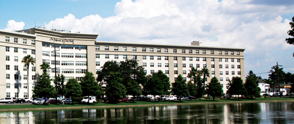 A commercial building in the distance, across a body of water