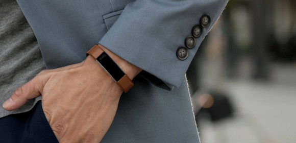 A man wearing a Fitbit Alta HR fitness band.