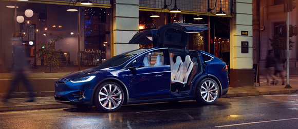 Model X on a street with open Falcon Wing Doors