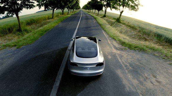 Silver Model 3 with a glass roof.