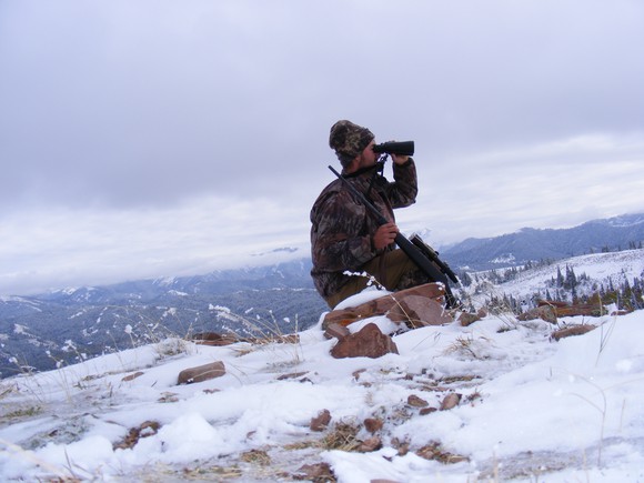 Man winter deer hunting in the mountains