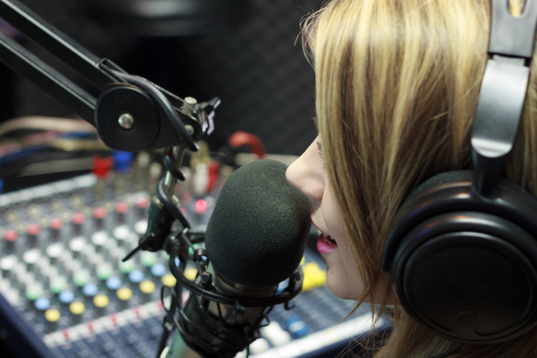 Radio DJ in Front of Soundboard