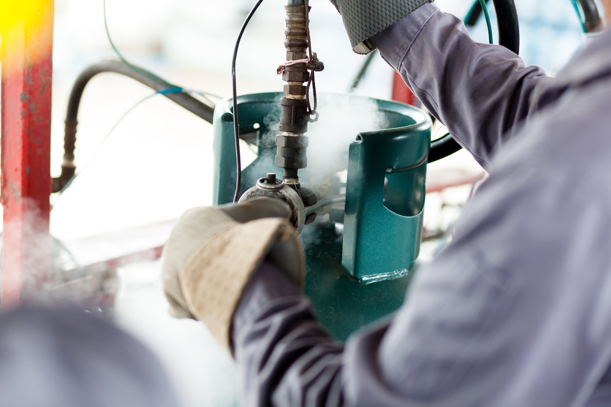 A man refuels a propane tank