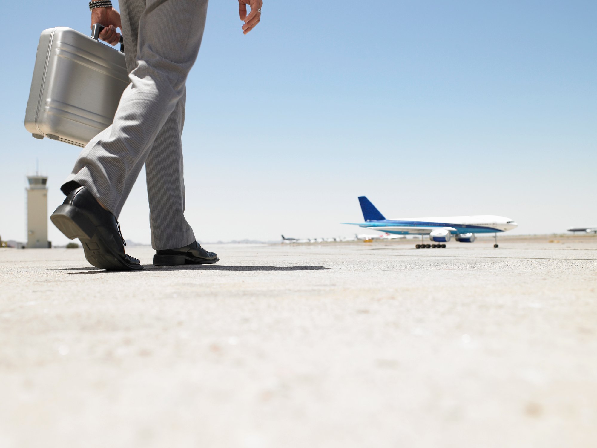 Businessman walking toward plane