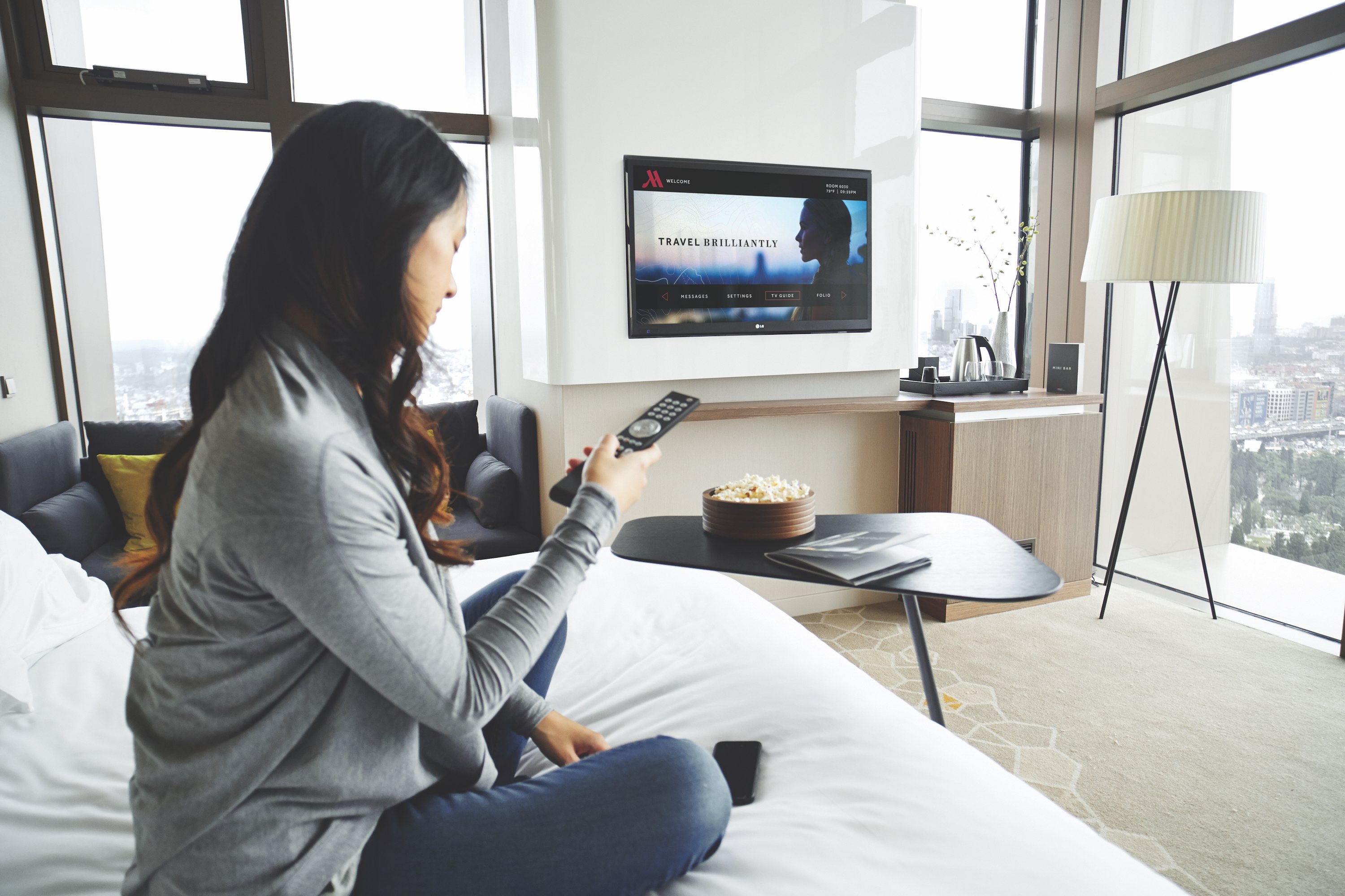 Guest sitting in a Marriott hotel room.