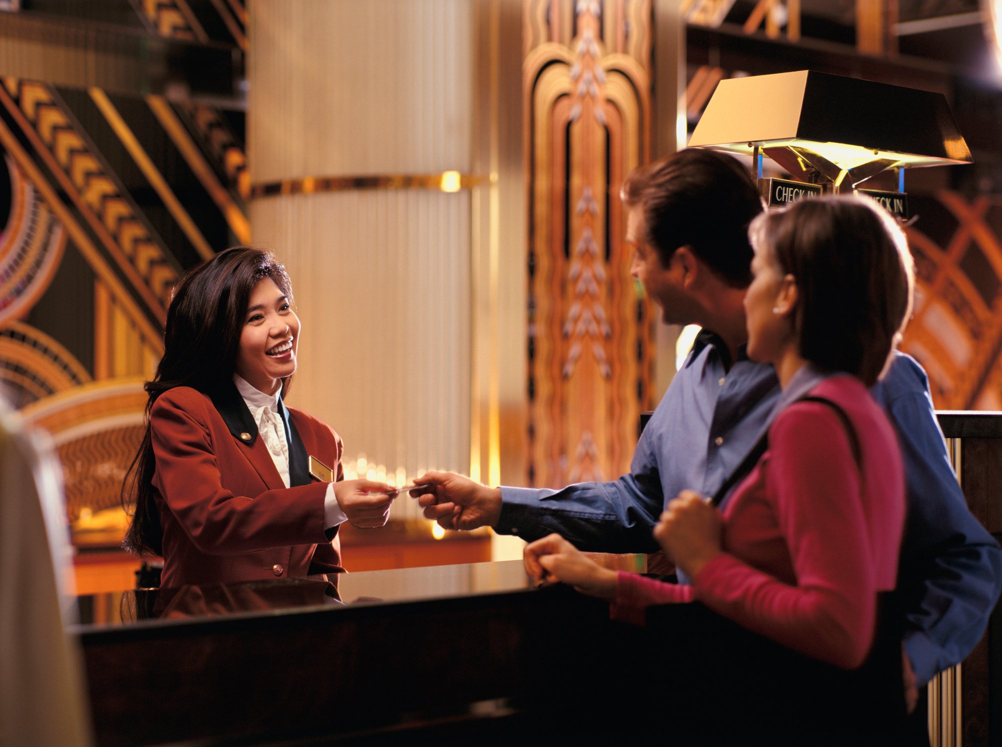A couple checks into a hotel.